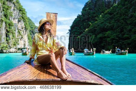 Asian Women In Front Of A Longtail Boat At Kho Phi Phi Thailand At Pileh Lagoon