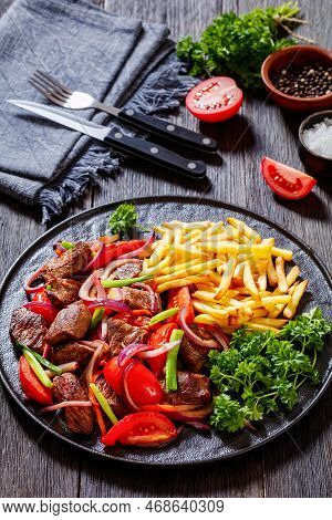 Lomo Saltado, Peruvian Dish Of Stir-fried Slices Of Beef Sirloin, Onions, Yellow Peruvian Chilis, An