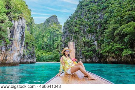 Asian Women In Front Of A Longtail Boat At Kho Phi Phi Thailand At Pileh Lagoon