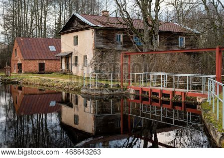 Water Mill On The Shore Of Lake And Its Reflection On The Surface Of The Water, Garsene, Latvia