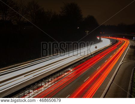Long Exposure, White Front And Red Rear Lights As Car Light Strips At Night, German Text For Exit An