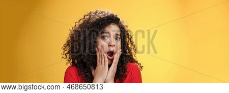Indoor Shot Of Shocked Female Drama Queen With Curly Hair Gasping In Surprise, Feeling Empathy And F