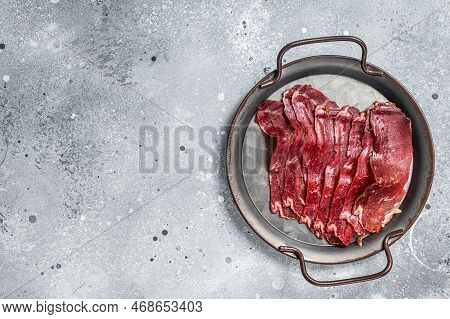 Sliced Basturma, Cured Beef Meat In Steel Tray. Gray Background. Top View. Copy Space.