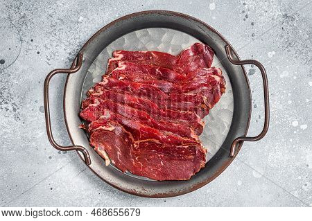 Sliced Basturma, Cured Beef Meat In Steel Tray. Gray Background. Top View.