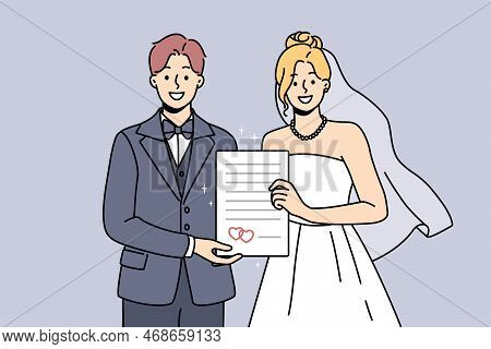 Smiling Bride And Groom Holding Marriage Certificate Excited About Starting Family. Happy Couple In 