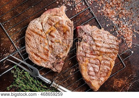 Bbq Grilled Pork Loin Steaks From Neck Fillet Meat On Grill. Dark Background. Top View.