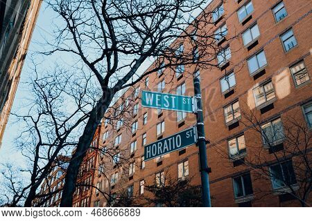 Street Name Signs On The Corner Of West And Horatio Streets In Meatpacking District, New York City, 