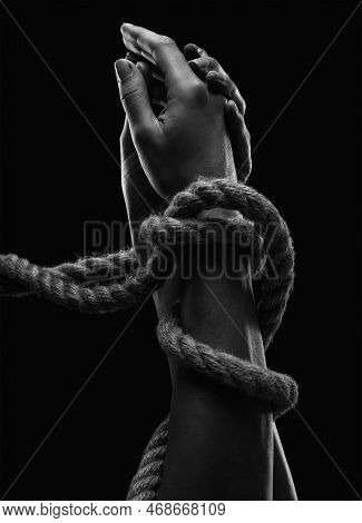 Hands Of A Man With Hands Tied With Ropes. Photo Black And White