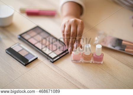 Cropped Of Female Blogge Showing Various Beauty Products