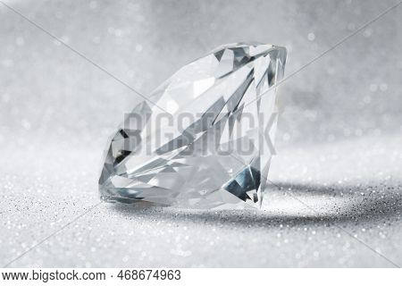 Beautiful Dazzling Diamond On Shiny Glitter Background, Closeup. Precious Gemstone