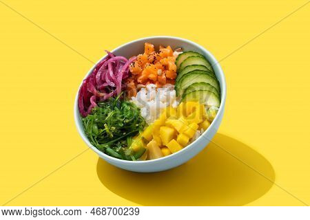 Poke Bowl With Rice, Salmon,cucumber,mango,onion,wakame Salad, Poppy Seeds Ands Sunflowers Seeds On 