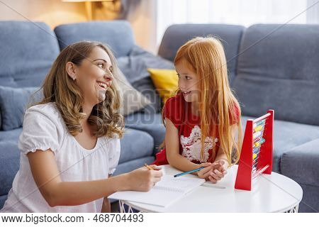 Mother Helping Daughter With School Project And Homework, Studying Math, Practicing Summation And Su