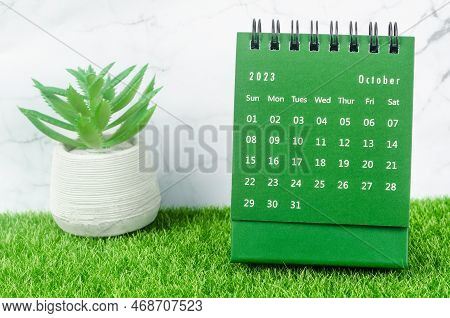 Green October 2023 Monthly Desk Calendar For 2023 Year On Grass.