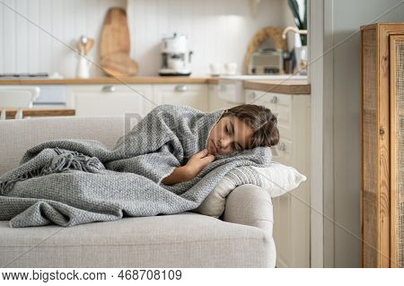 Unwell Daughter Lying On Sofa At Home While Mom On Work. Upset Child Girl Feels Exhaustion Have Day 