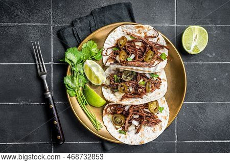 Mexican Beef Barbacoa Tacos With Cilantro And Onion. Black Background. Top View