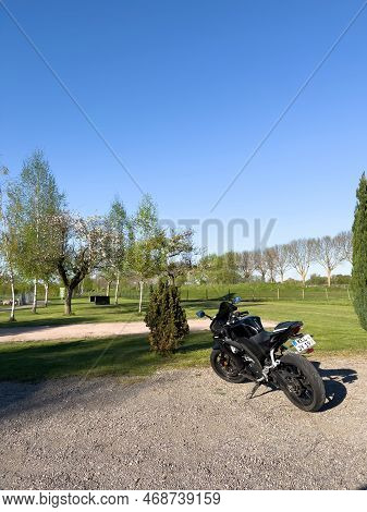 Germany - Aug 18, 2022: Luxury Yamaha Yzf-r125 Motorcycle Parked In Front A Golf Lawn