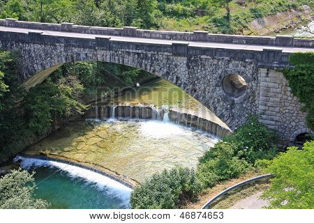 Old Stone Bridge Over The Brook In The Mountains With