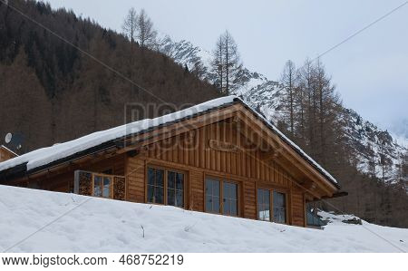 Predoi, Italy - December 29, 2022: View Of  Typical Mountain Cabin Or Chalet In Valle Aurina With Sn