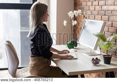 Successful Female Grapic Designer Watching Tutorial About Creative Ideas At Computer During Working 
