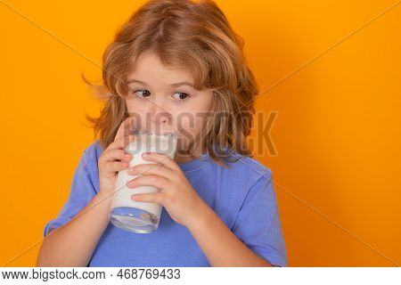 Organic Milk. Beautiful Smiling Child With A Glass Of Milk. Cute Boy In Blue Shirt Holding Glass Of 