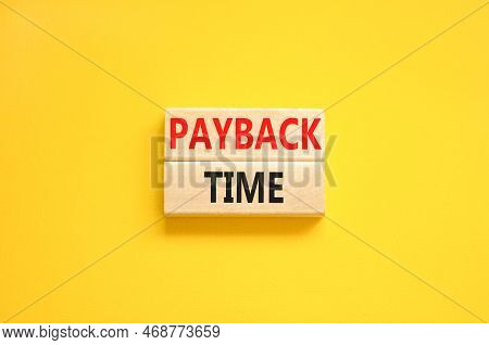 Payback Time Symbol. Concept Words Payback Time On Wooden Blocks. Beautiful Yellow Table Yellow Back