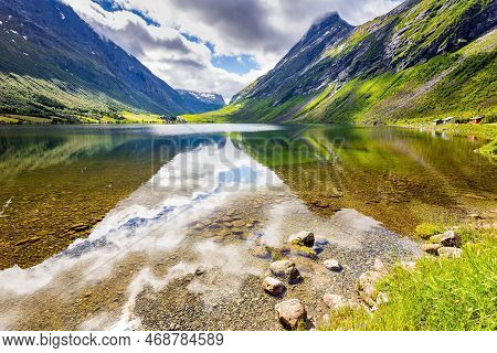 Smooth Water Reflects The Mountains