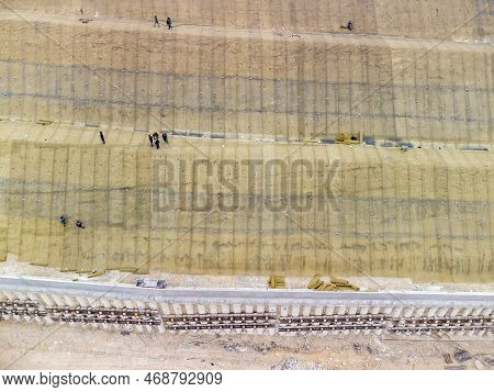 Mountain Road Constraction. Workers Reinforce The Slope Over The New Road. Road Construction In Prog