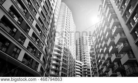 The Narrow Passage Between Modern Residential Buildings. Walls Of High-rise Apartment Buildings And 