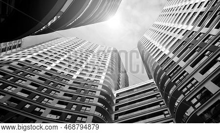 The Narrow Passage Between Modern Residential Buildings. Walls Of High-rise Apartment Buildings And 