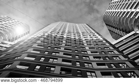 The Narrow Passage Between Modern Residential Buildings. Walls Of High-rise Apartment Buildings And 