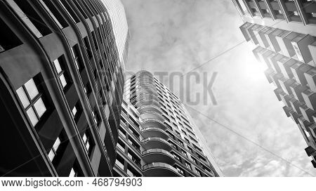 The Narrow Passage Between Modern Residential Buildings. Walls Of High-rise Apartment Buildings And 
