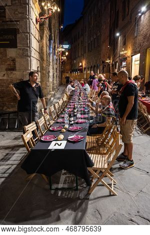 Siena, Italy - August 15 2022: The Grand Contrada Dinner Of The Civetta Or Little Owl Contrada On Th