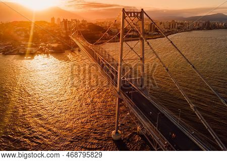 Old Cable Bridge With Sunset Light In Florianopolis, Brazil. Aerial View