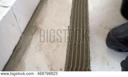 Applying Mortar When Laying A Wall Of Foam Blocks. A Bricklayer Makes A Concrete Wall From A Cement 