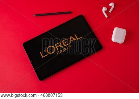 Tula, Russia - October 19, 2021: Loreal Group Displayed Modern Laptop On Red Background