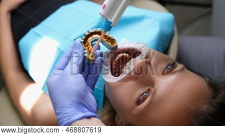 Orthodontist Works With Shape Of Jaw Cast In Process Of Prosthetics Of Facial Arch Of Woman. Orthodo