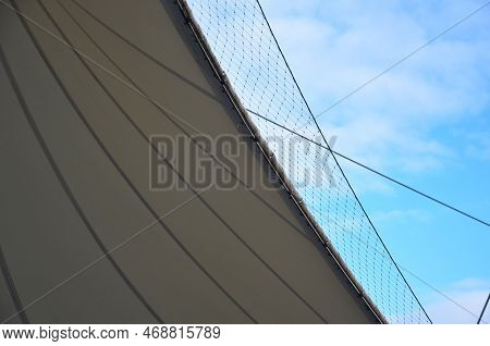 White Tarpaulin Taut, Shading From The Sun And Rain Over The Terrace Of The Restaurant, On The Playg