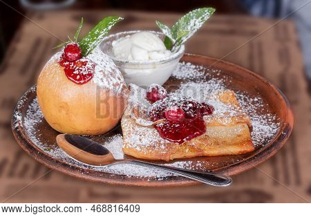Pancakes With Jam And A Baked Apple On A Ceramic Plate