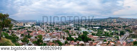 Panoramic View Over Old Town And Modern Architecture Of Tbilisi, Georgia. Cityscape Of Mtkvari Or Ku