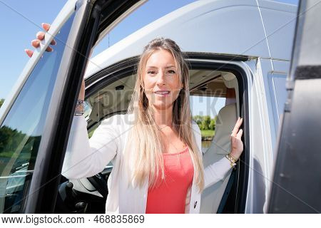 Beautiful Blonde Caucasian Woman Relaxing In Motor Camper Rv Home Campervan During Vanlife Day