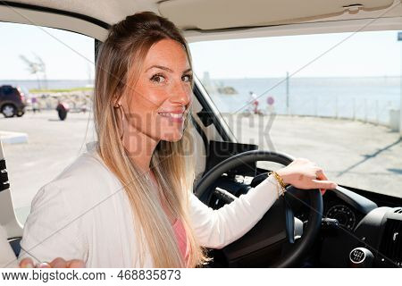 Smiling Beautiful Blonde Woman Happy Driver In Van Campervan During Vanlife Lifestyle Concept