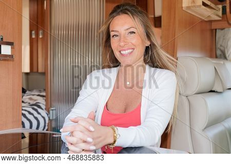 Young Beautiful Woman Sitting In Her Camper Van Smiling Enjoy Vanlife In Motor Home