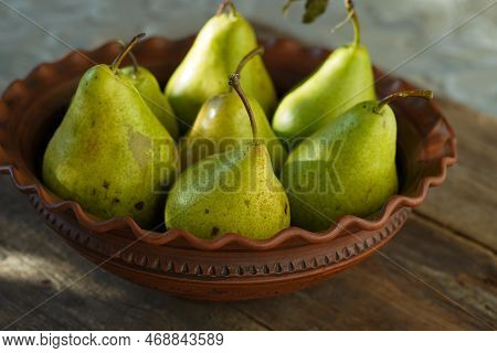 Pears On A Wooden Background. Fruit Harvest. Autumn Still Life. Pear Variety Bera Conference.