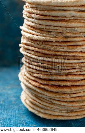 Flatbread Lavash, Chapati, Naan, Heap Of Tortilla On A Blue Background Homemade Flatbread Stacked.