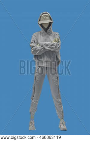Full Length Image Of A Female Display Mannequin Wearing Gray Sweatsuit Isolated On Blue Background