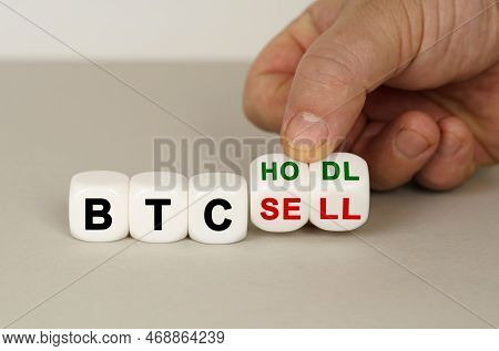 On A Gray Surface Are White Cubes With The Inscription - Btc Hodl To Btc Sell. Two Dice In Hand. Bus