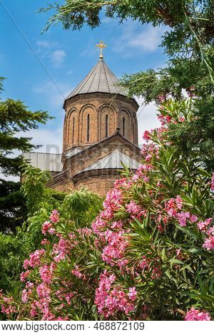 Domes Of Metekhi Church In Flowers In Old Town Of Tbilisi, Georgia. Virgin Mary Assumption Church Of