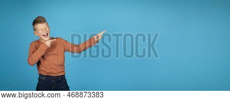 Cheerful Preteen Boy Laughing And Pointing Aside At Copy Space