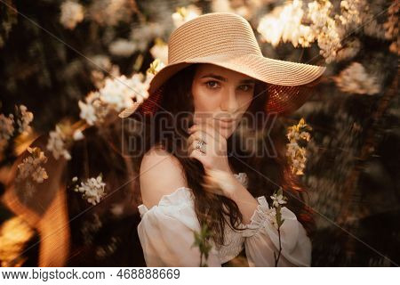 Portrait Of A Romantic Girl In A Blooming Garden With Elements Of Phantasmagoria.
