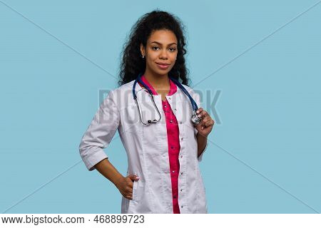 African American Female Doctor Medical Employee Posing On Blue Studio Background. Woman Medical Stud